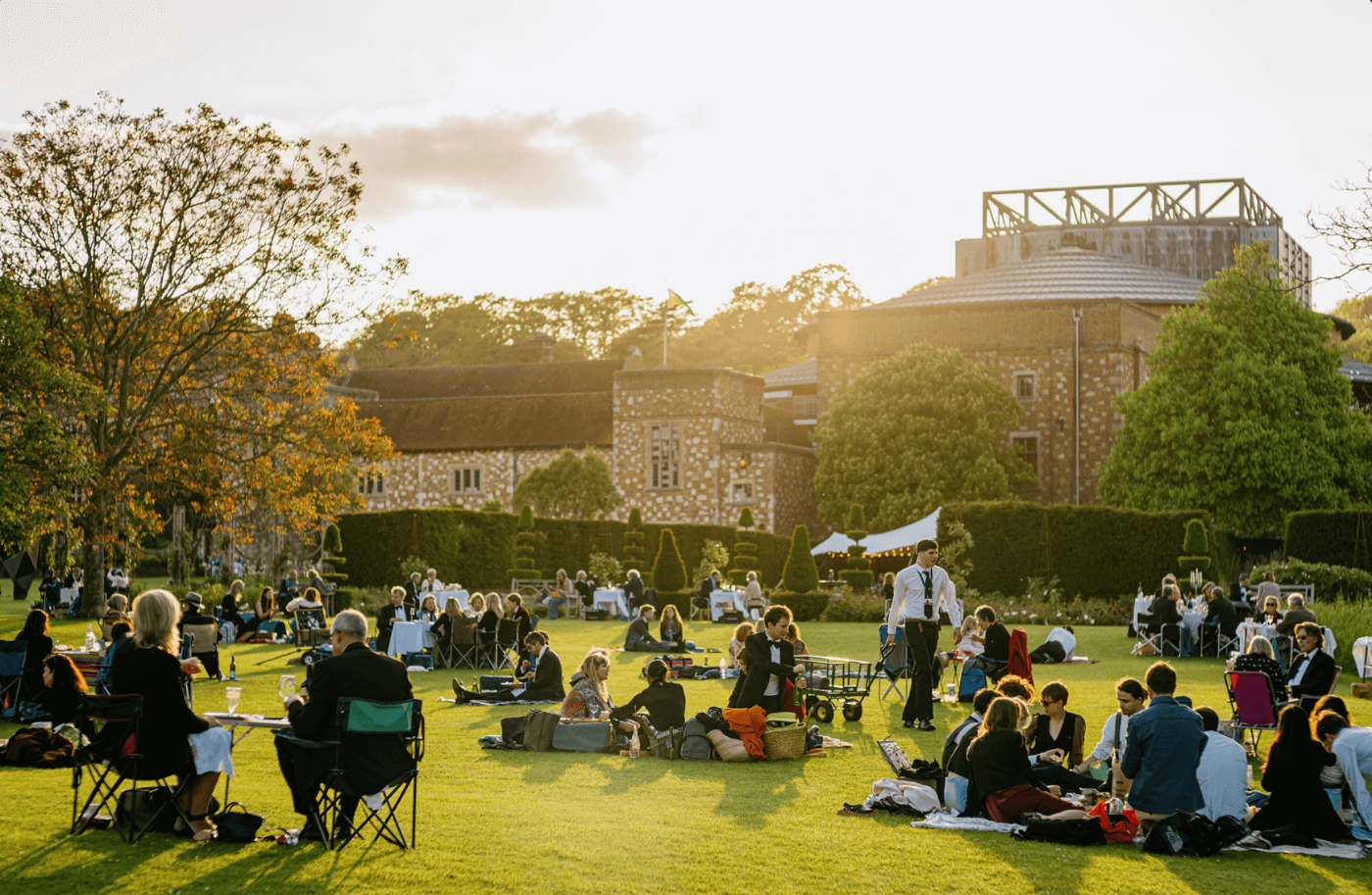 Glyndebourne IV drip therapy event with people enjoying outdoor dining.